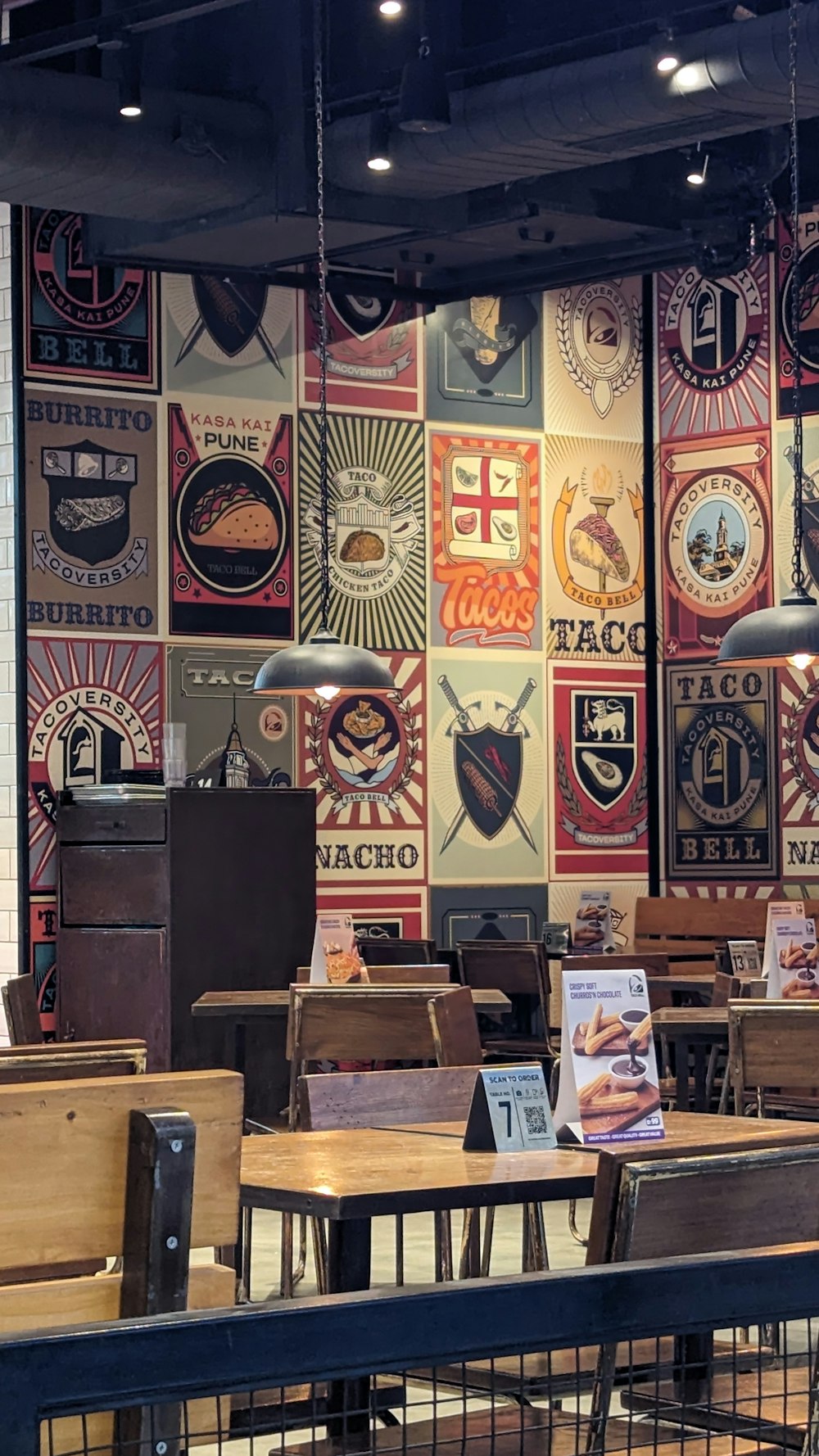 a restaurant with tables and chairs and signs on the wall