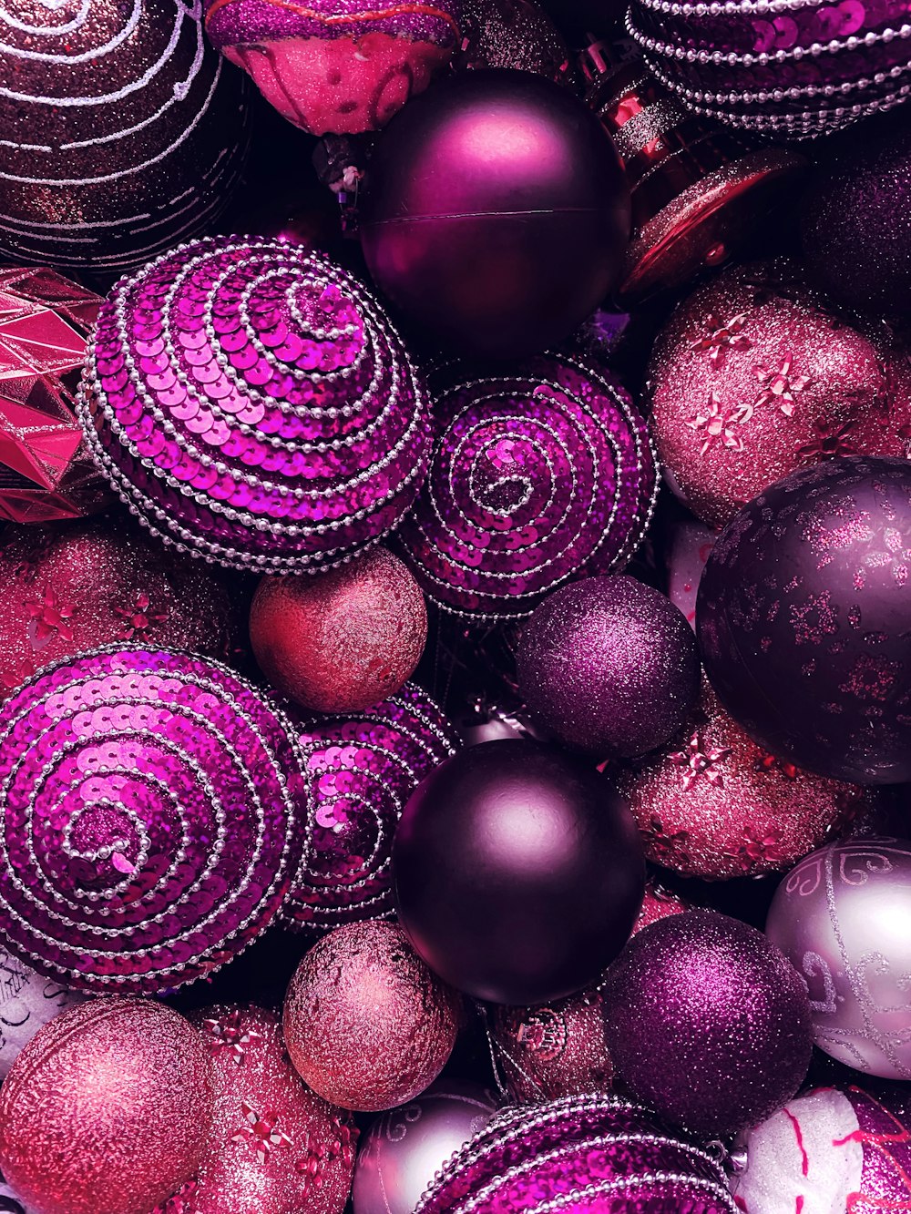 a pile of purple and red ornaments sitting on top of each other