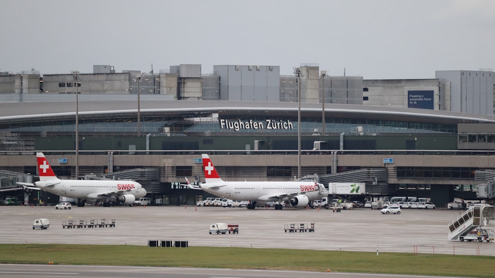 a couple of airplanes that are on a runway