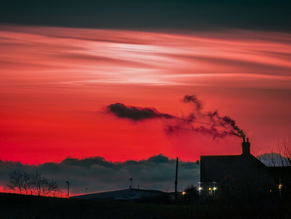 a red sky with smoke coming out of it