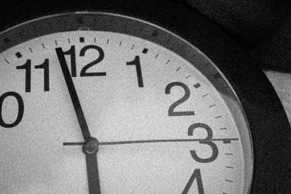 a black and white photo of a clock