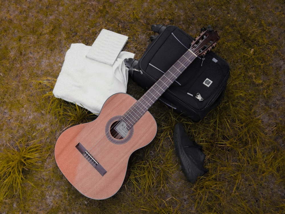 a ukulele and a suitcase on the ground