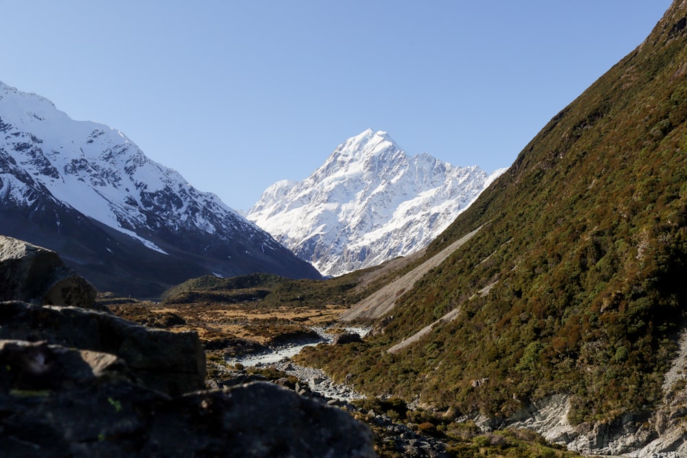 a mountain range with a stream running through it