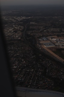 Aerial view of fiber optic cables laid out across a busy urban landscape at dusk