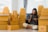 Woman using a tablet inside a warehouse with stacked boxes around.