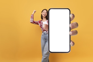 A friendly person holding a smartphone, ready to assist with inquiries.