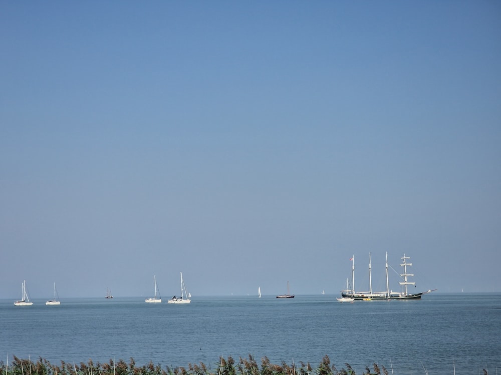 a group of boats floating on top of a large body of water