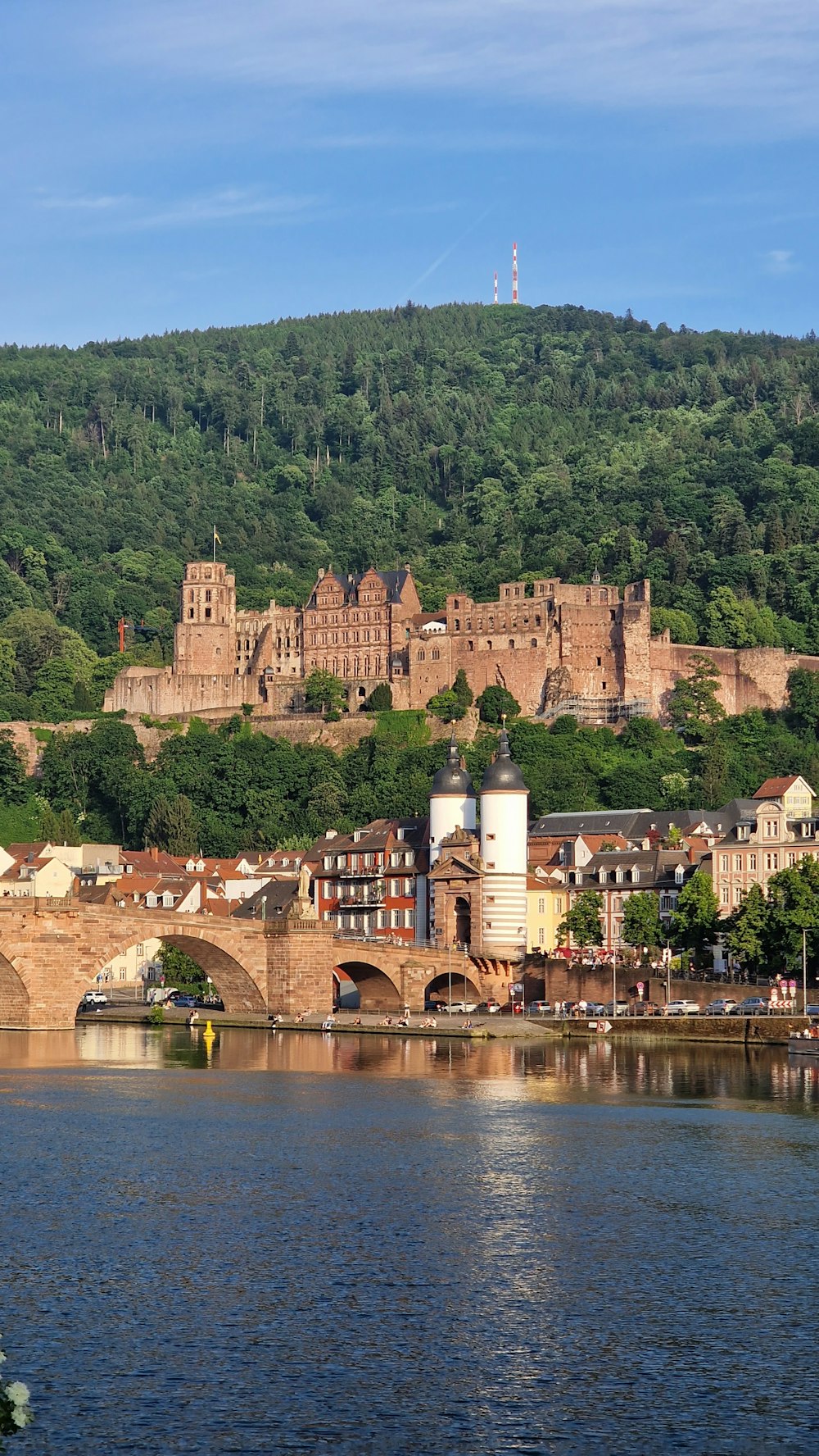 a bridge over a body of water with a castle in the background