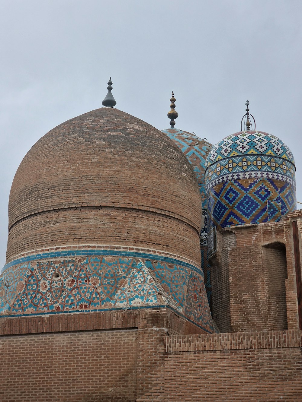 a large brick building with two domes on top of it