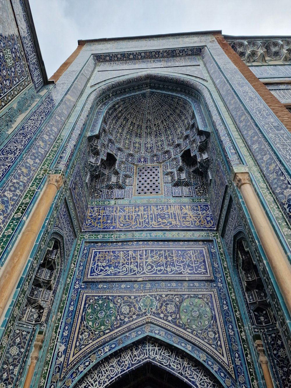 a large ornate building with blue and green tiles