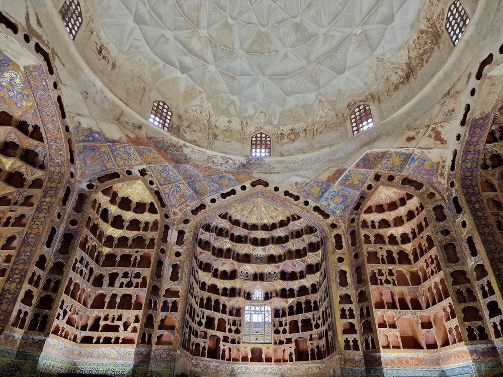 the ceiling of a building with intricate designs