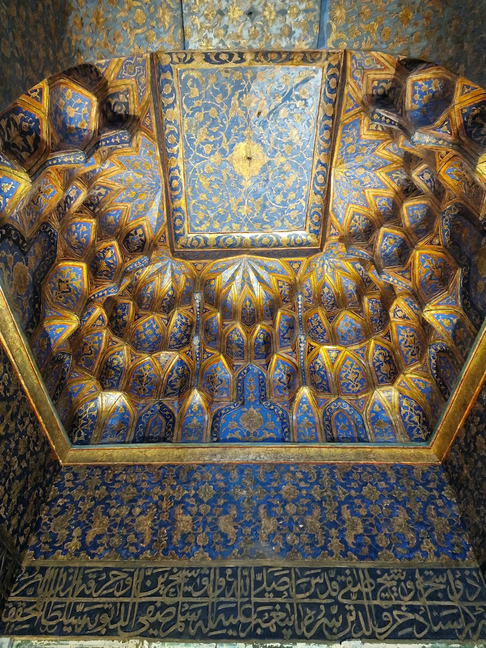 a blue and gold decorated room with a clock on the wall