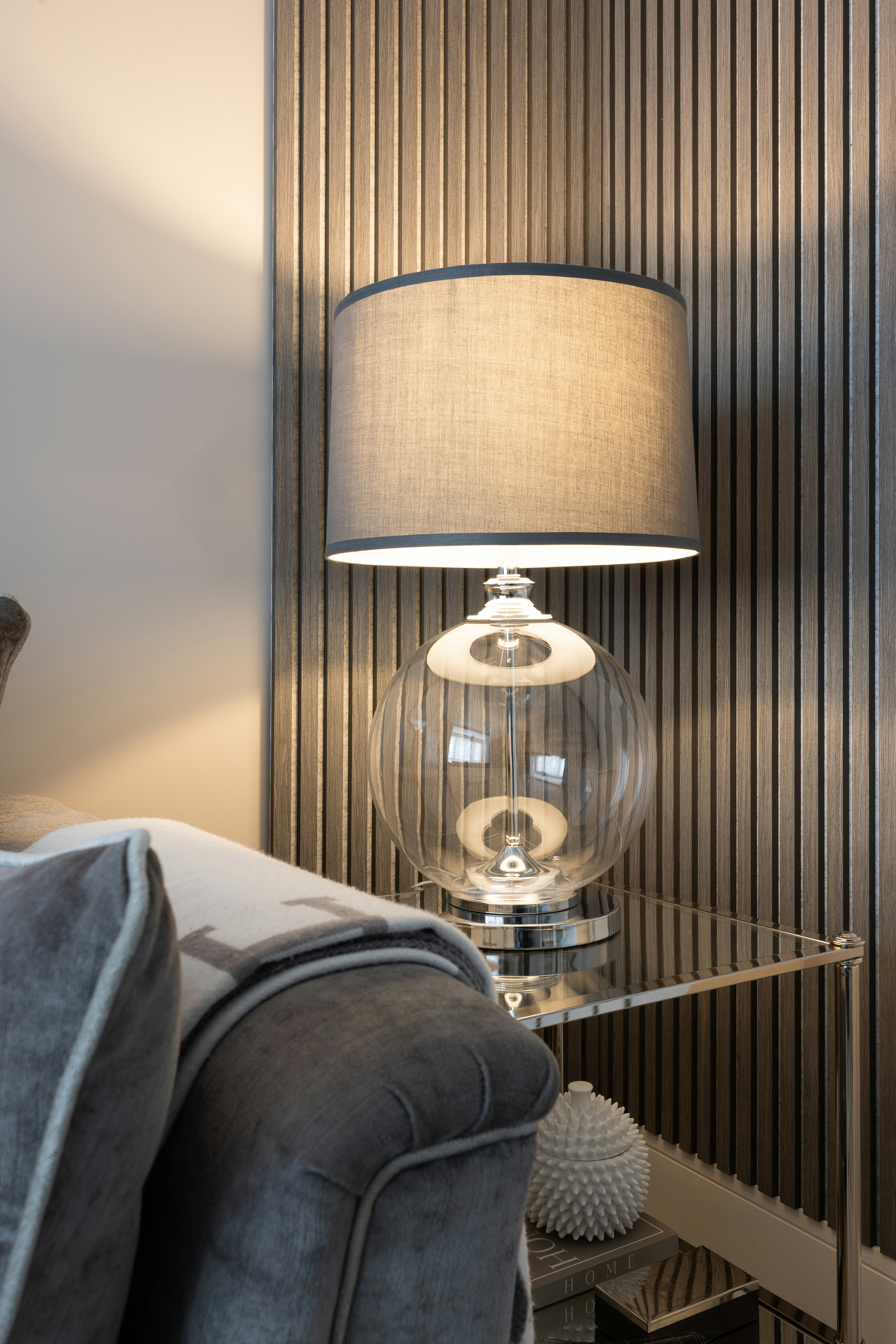 a living room with a couch and a lamp