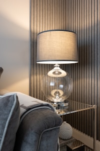 a living room with a couch and a lamp