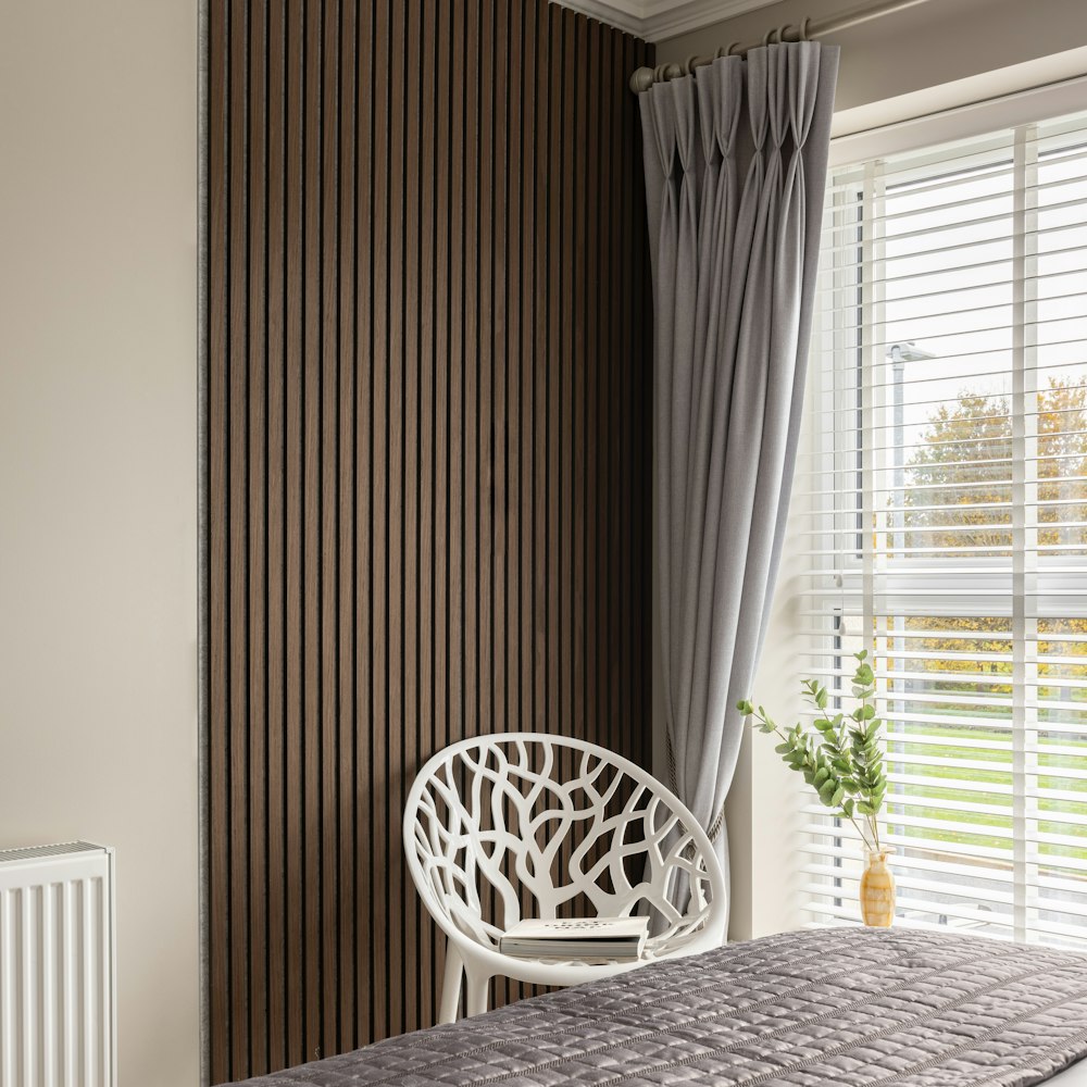 a bedroom with a bed and a window with blinds