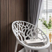 a white chair sitting next to a window