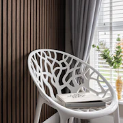 a white chair sitting next to a window