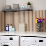 a white washer sitting next to a dryer on top of a counter