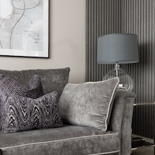 a living room with a couch and a lamp