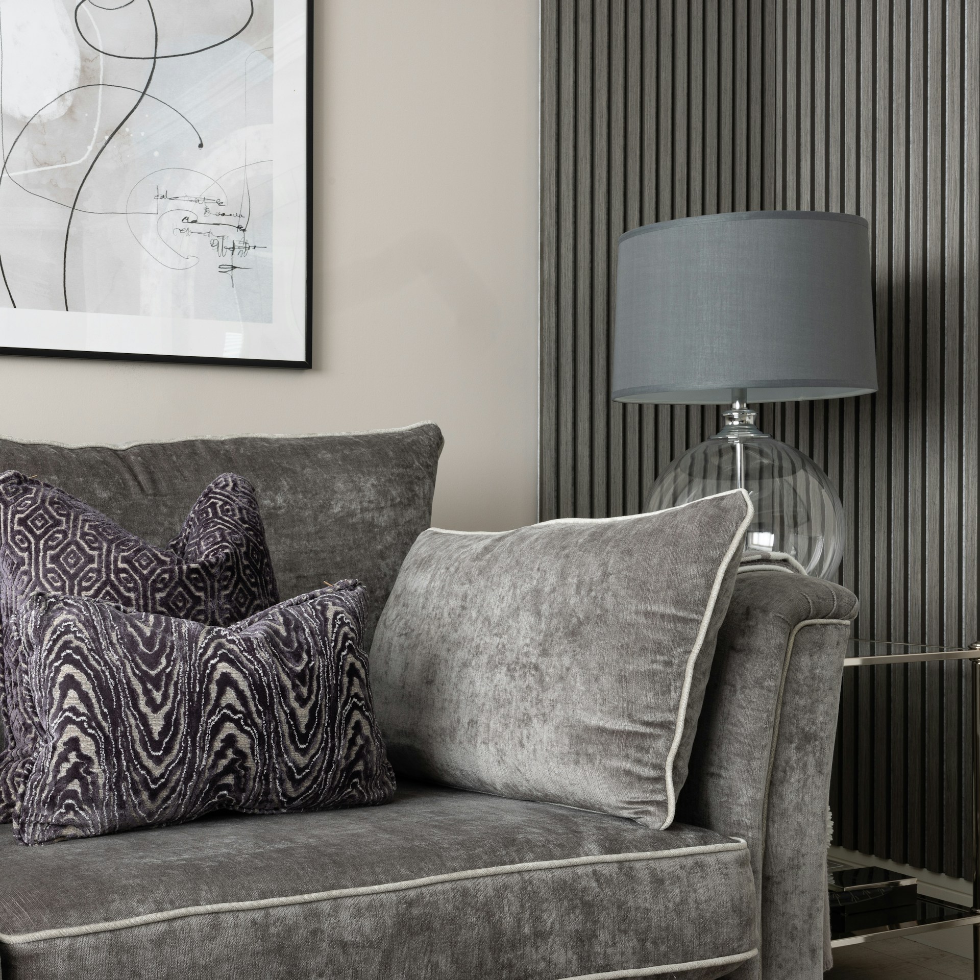 a living room with a couch and a lamp