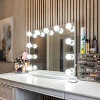 a vanity with a mirror and lights on it