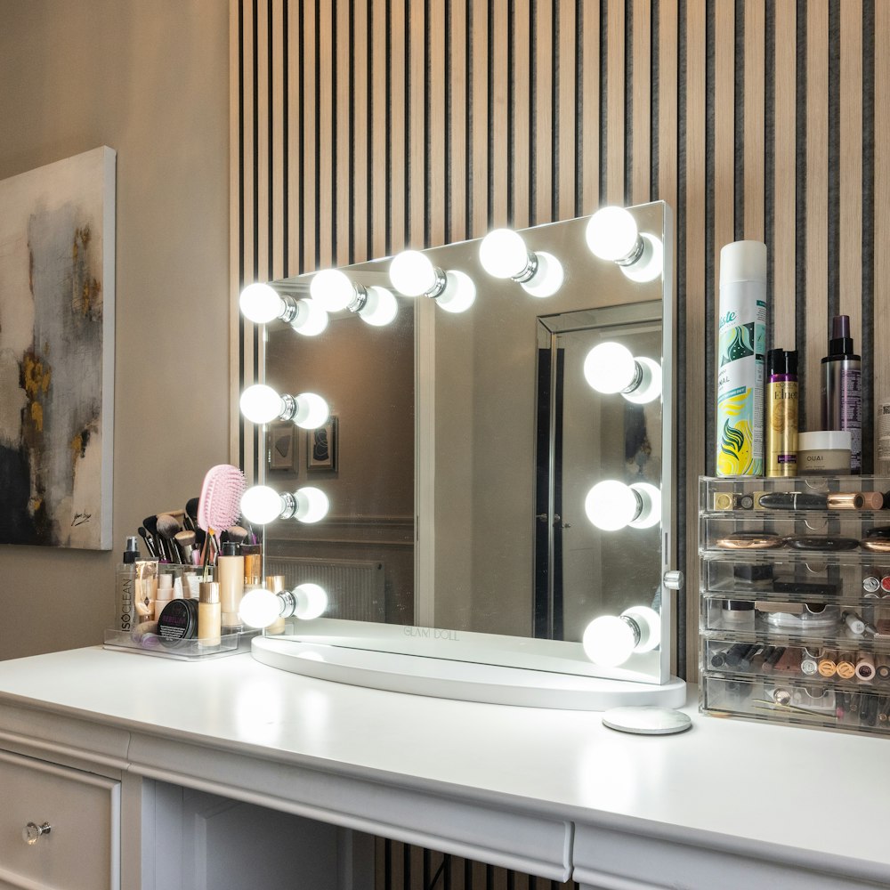 a vanity with a mirror and lights on it