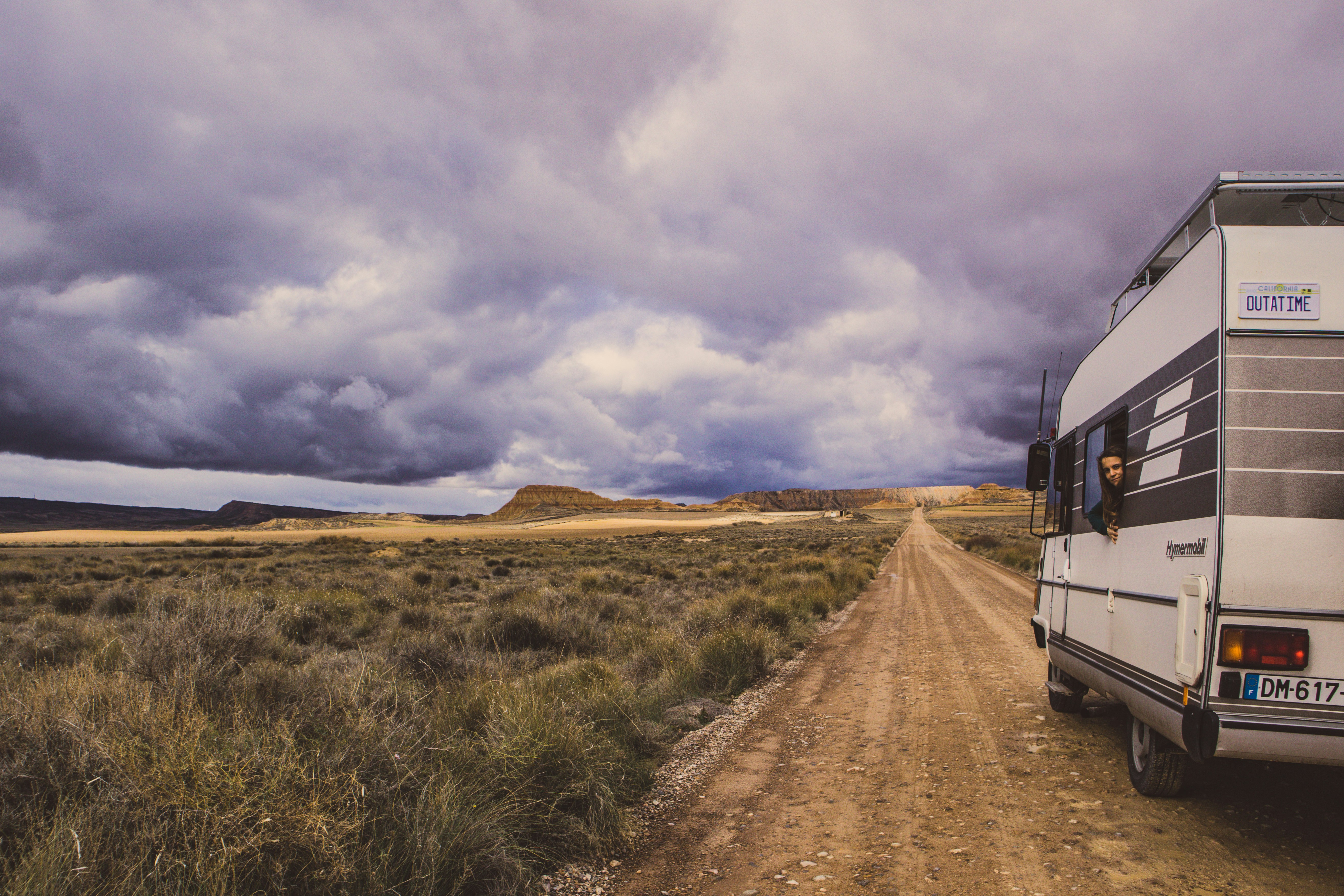 a motor home parked on a dirt road