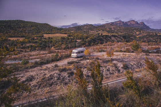 A scenic view of a recreational vehicle parked in a beautiful landscape.