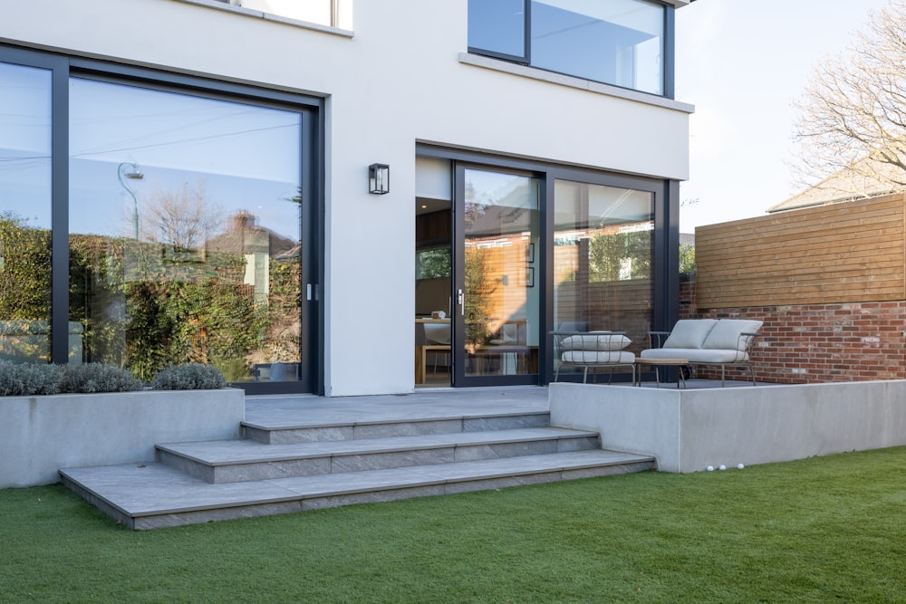 a house with a lawn and steps leading to it