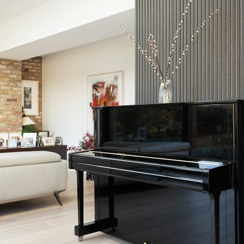 a living room with a piano and a couch