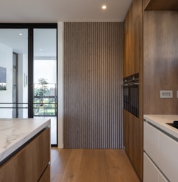 a kitchen with wooden cabinets and white counter tops