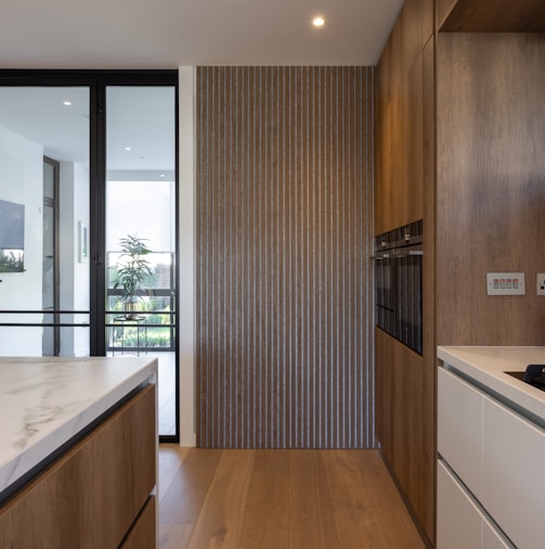 a kitchen with wooden cabinets and white counter tops