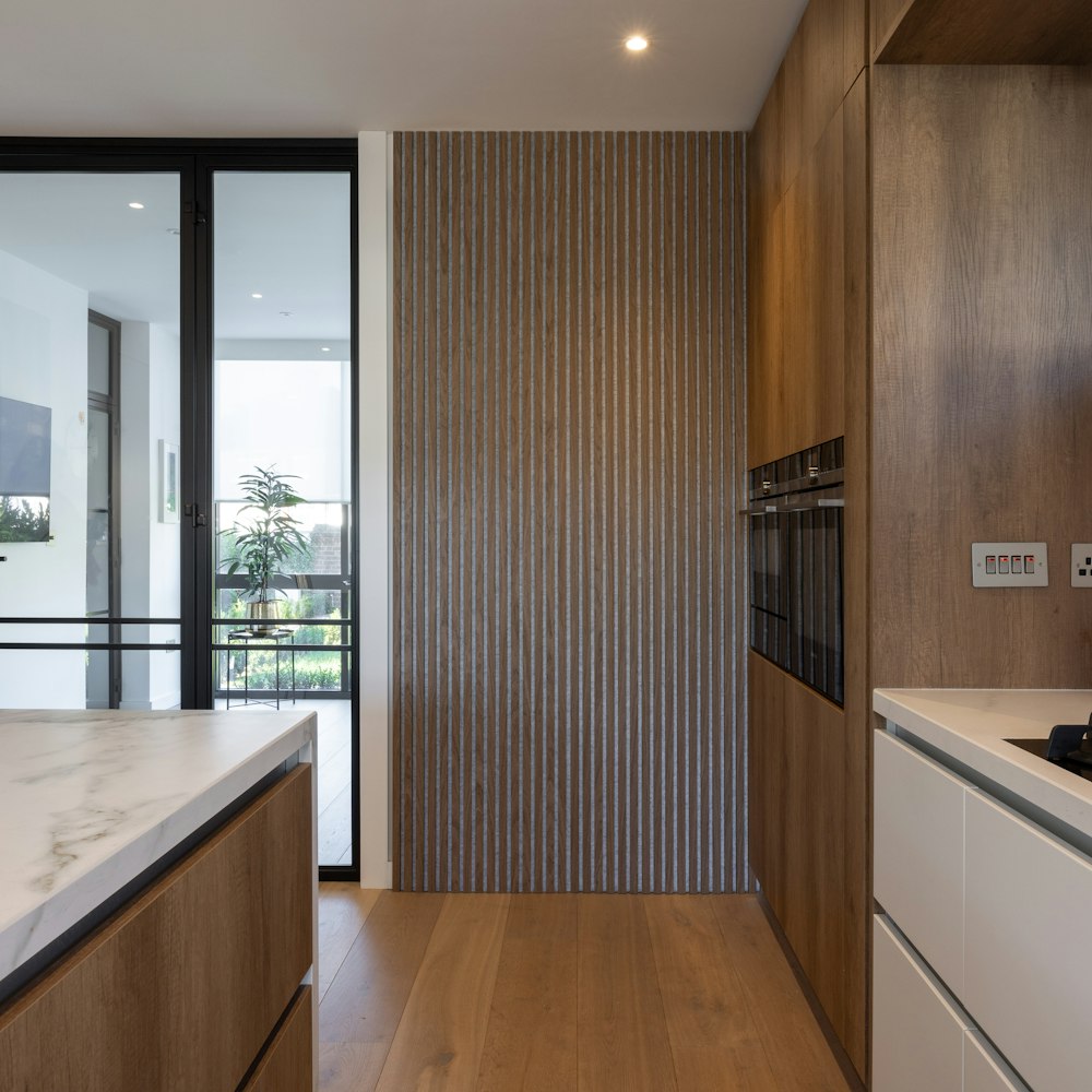 a kitchen with wooden cabinets and white counter tops