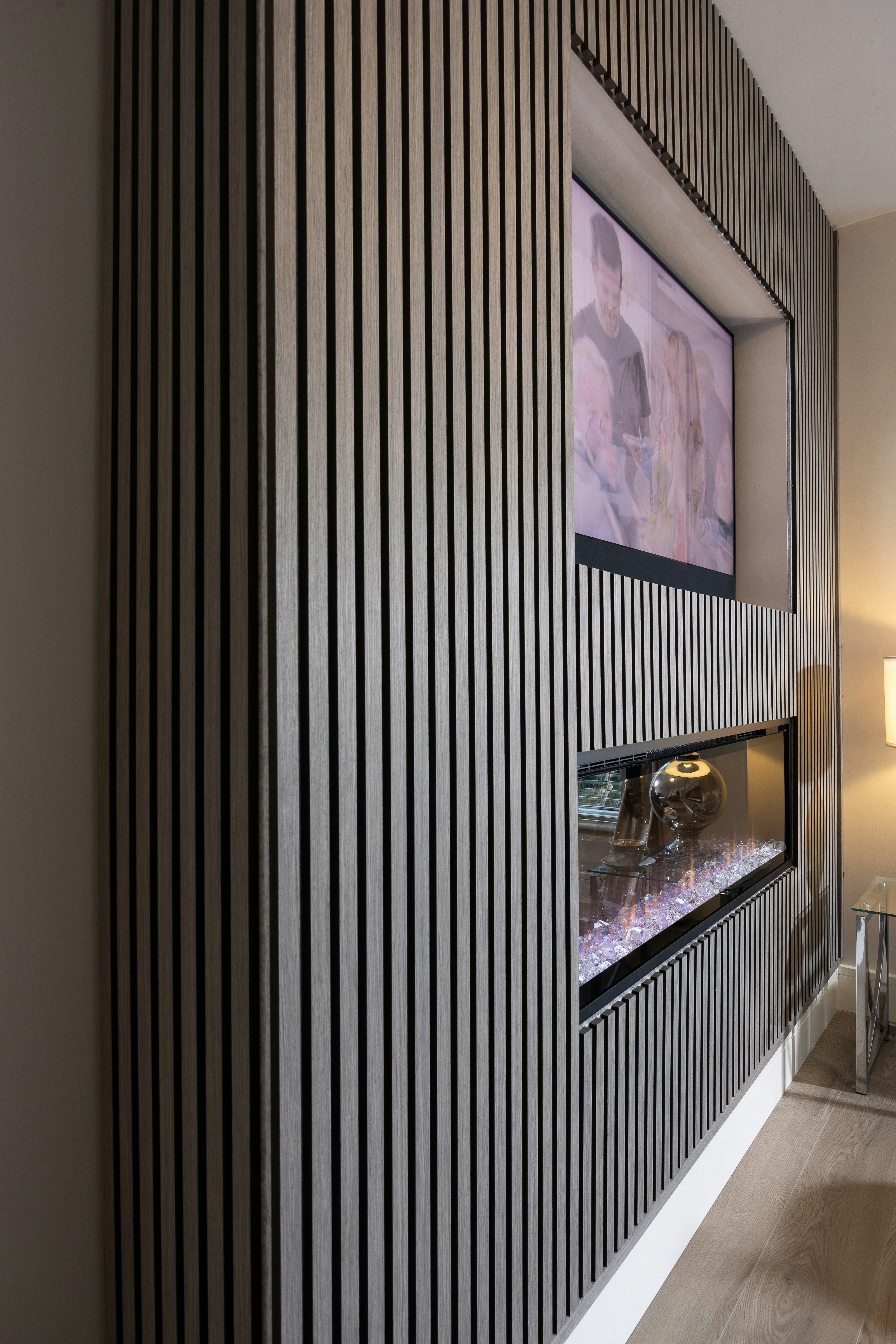 a living room with a fireplace and a picture on the wall