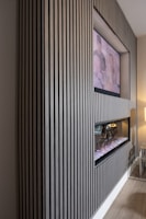 a living room with a fireplace and a picture on the wall