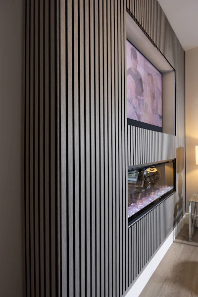 a living room with a fireplace and a picture on the wall