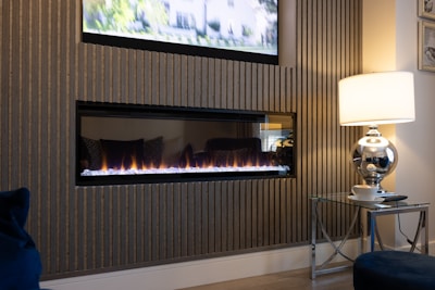 a living room with a television and a fire place