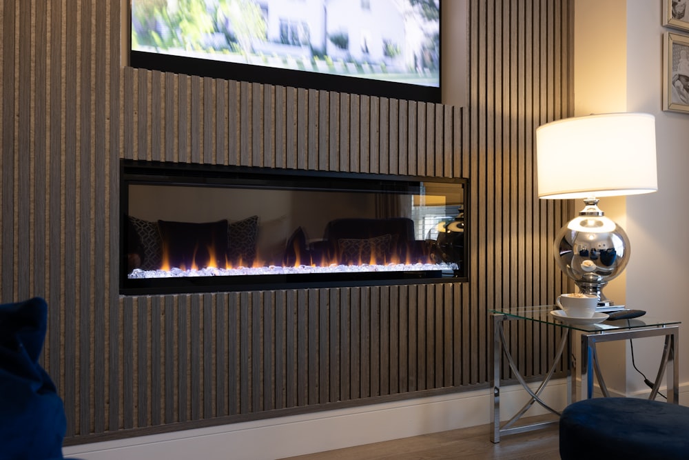 a living room with a television and a fire place