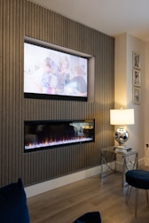 a living room with a fireplace and a flat screen tv