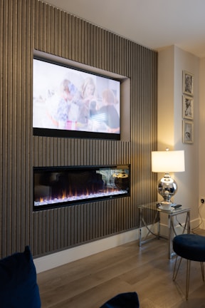 a living room with a fireplace and a flat screen tv