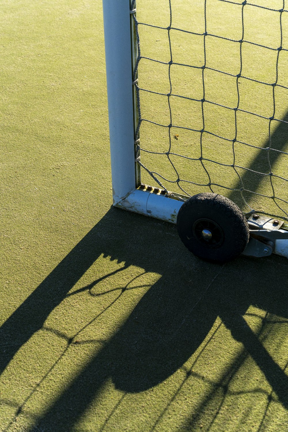 a soccer goal with a wheel attached to it