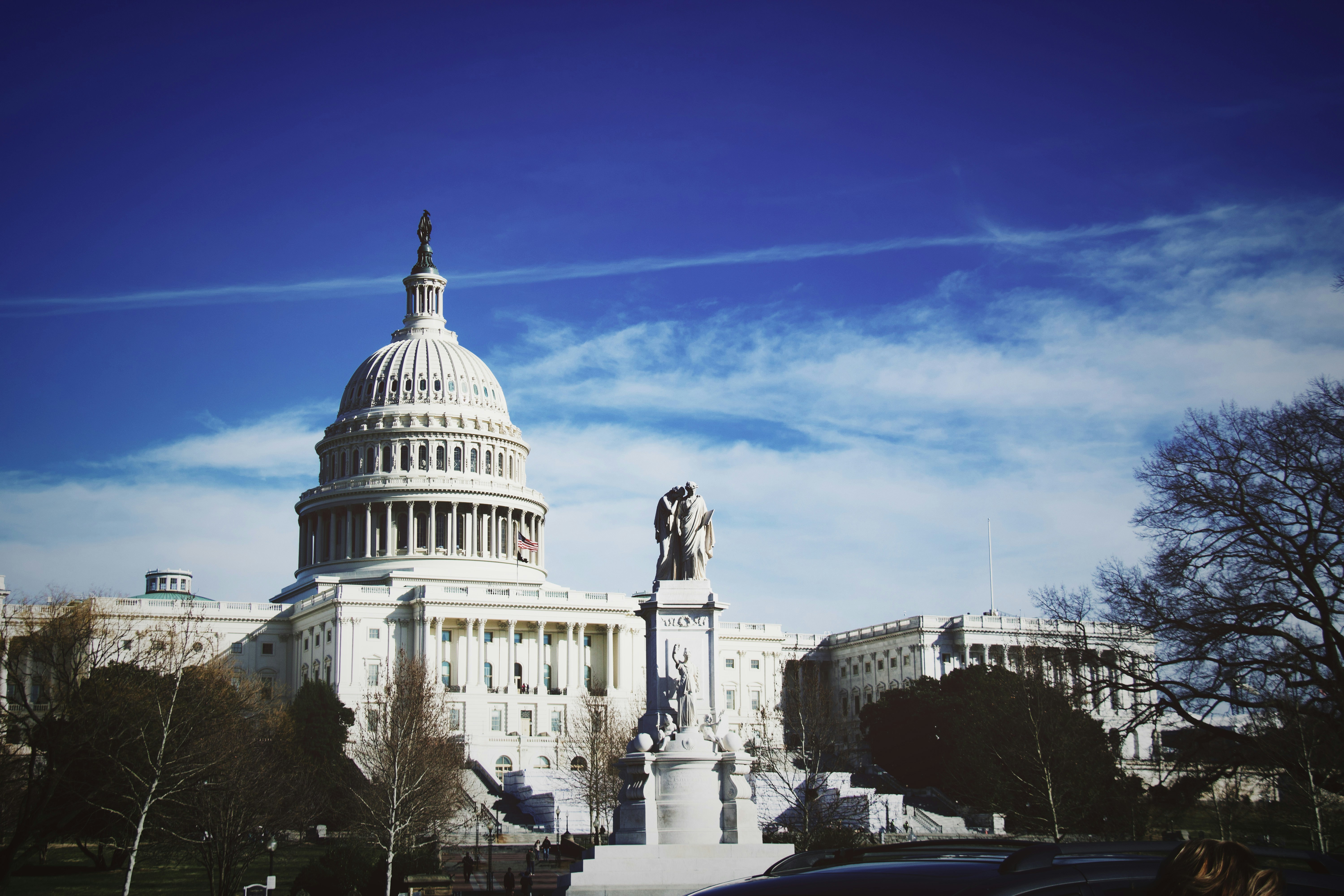 a large white building with a statue in front of it