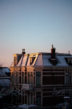 Modern luxury chalet facade at sunset with warm lighting