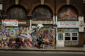 A vibrant East London street scene with a creative team working on digital devices.