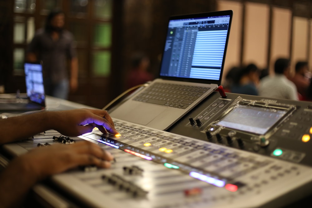 a laptop computer sitting on top of a sound board