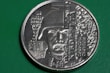 A commemorative coin featuring a detailed relief of a soldier's face wearing a helmet. The design includes intricate details of a building on the left and patterns or inscriptions that appear to be Cyrillic text. The dates 26.05.2014 to 21.01.2015 are visible on the coin's face.