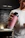 Smiling woman holding a Vitalis protein shake in a bright kitchen