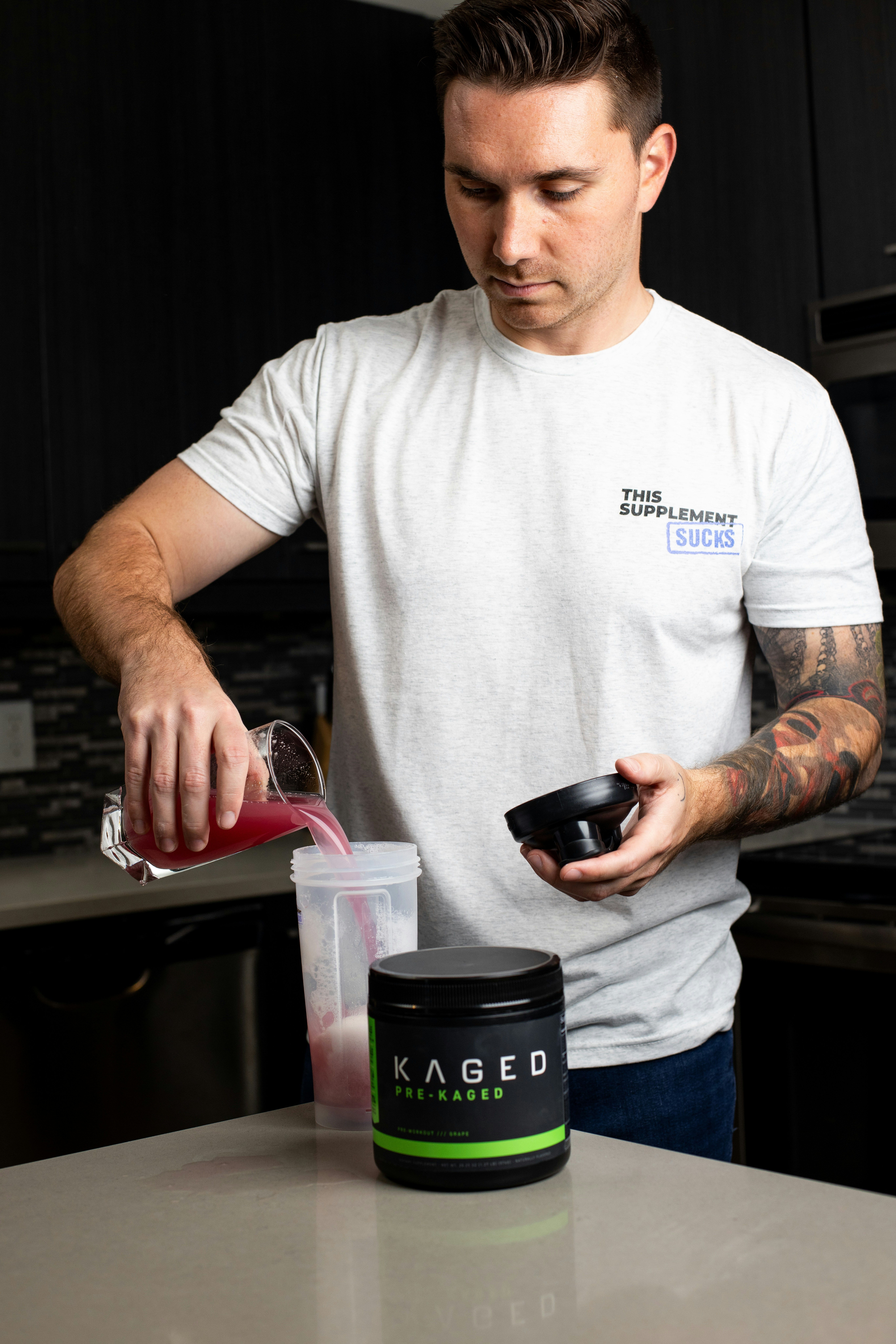 a man pouring a drink into a cup