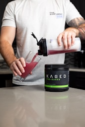 a man pouring a drink into a glass