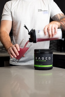 a man pouring a drink into a glass